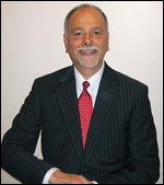 A man in a suit and tie standing.